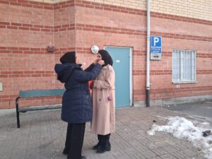 Rumki Chowdhry wraps the hijab on Nisha Begum. 